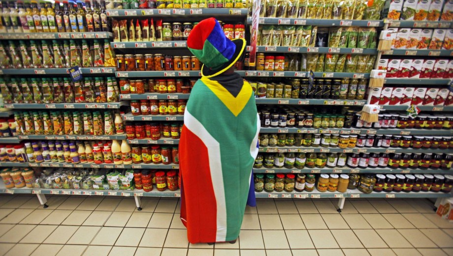 woman-south-african-flag-draped-around-her-shops-groceries-pretoria
